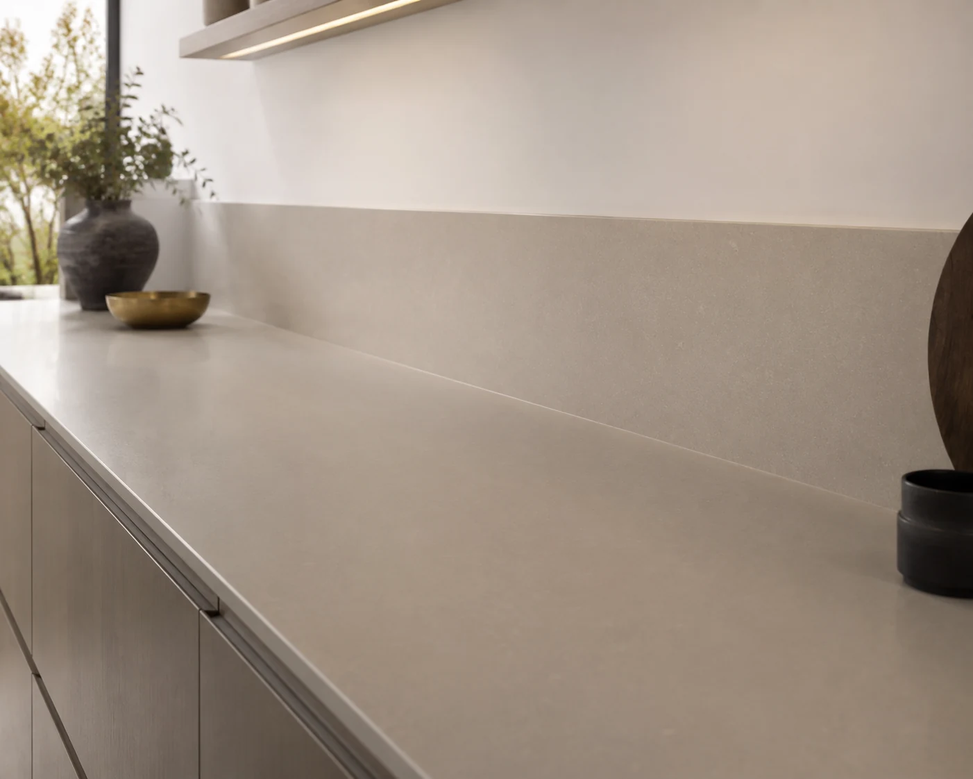 Solid surface worktop continuing into a matching integrated splashback
